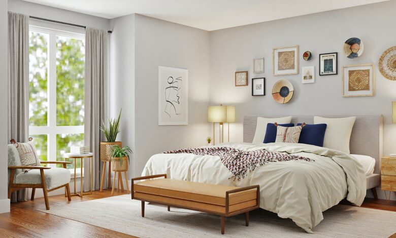 Belle chambre d'adulte blanche, avec un lit douillet et une simple et belle décoration.